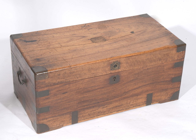 Appraisal: A COLONIAL TEAK AND BRASS BOUND TRAVELLING TRUNK with hinged