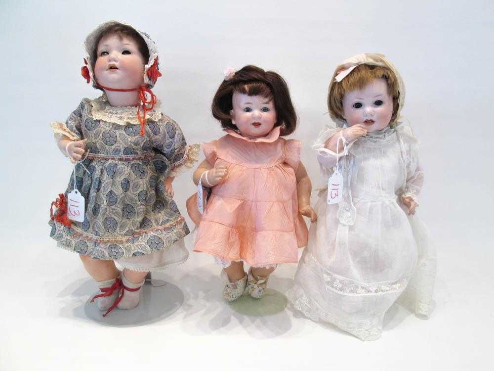 Appraisal: THREE ARMAND MARSEILLE BISQUE SOCKET HEAD DOLLS with dark brown