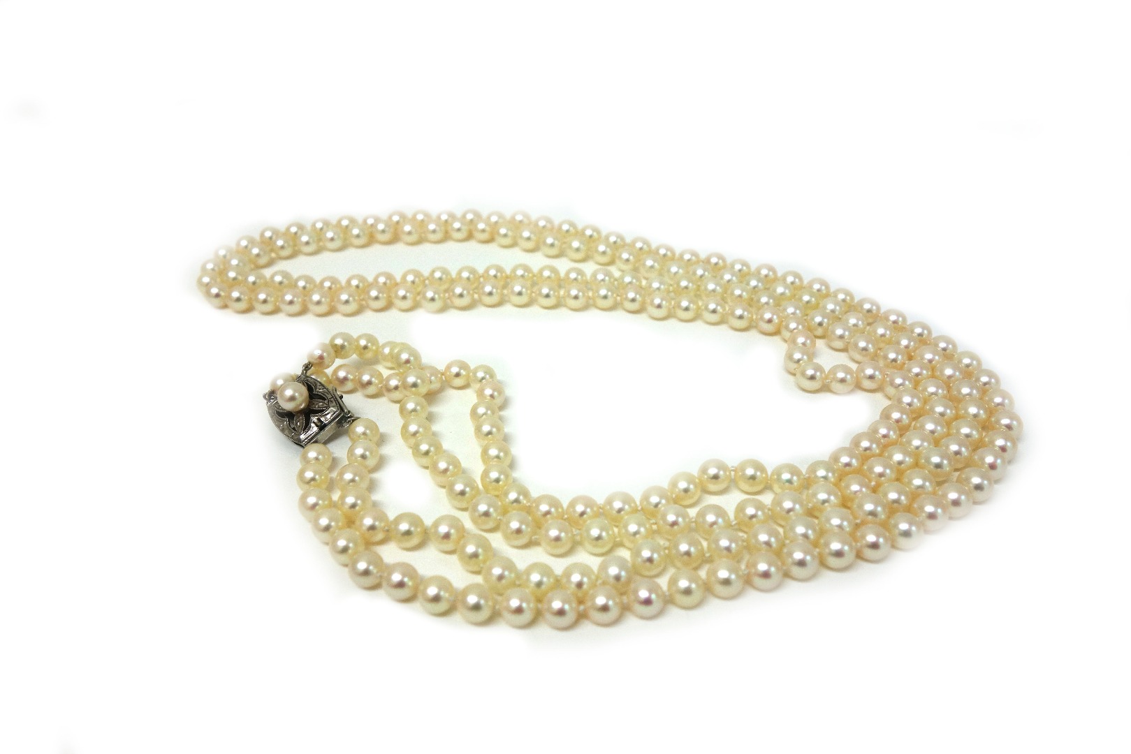 Appraisal: A two-row cultured pearl necklace on a pierced and engraved