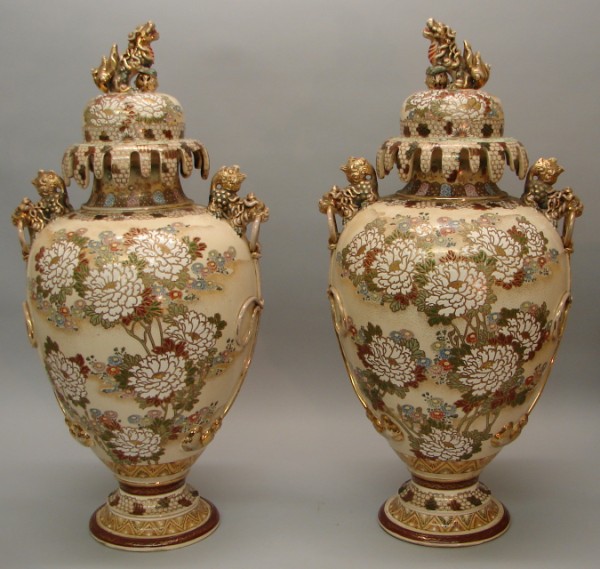 Appraisal: Lidded vases feature foo dog form handles applied cord decoration