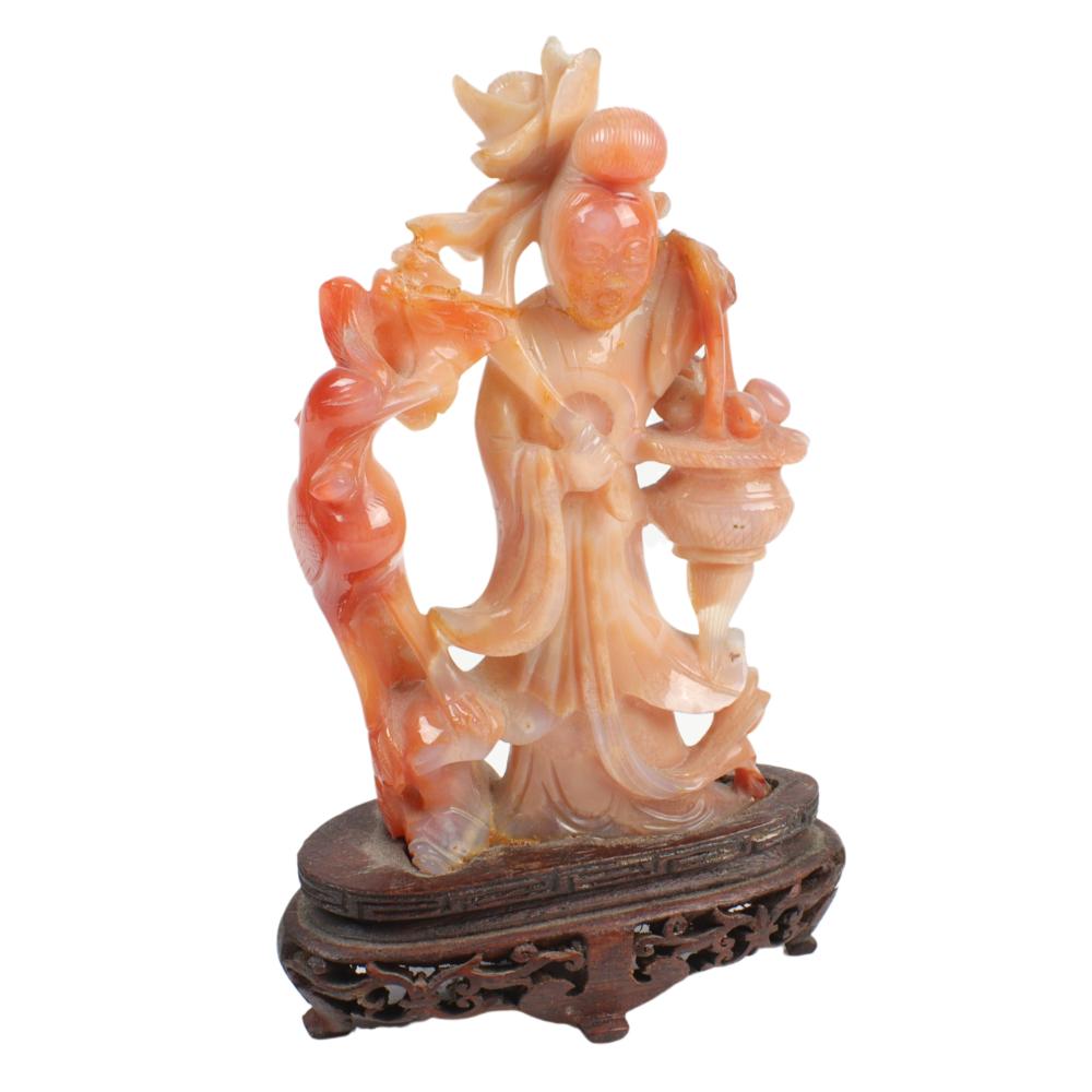 Appraisal: CHINESE ORANGE RUSSET CREAM HARDSTONE CARVED FIGURE OF GUANYIN ON