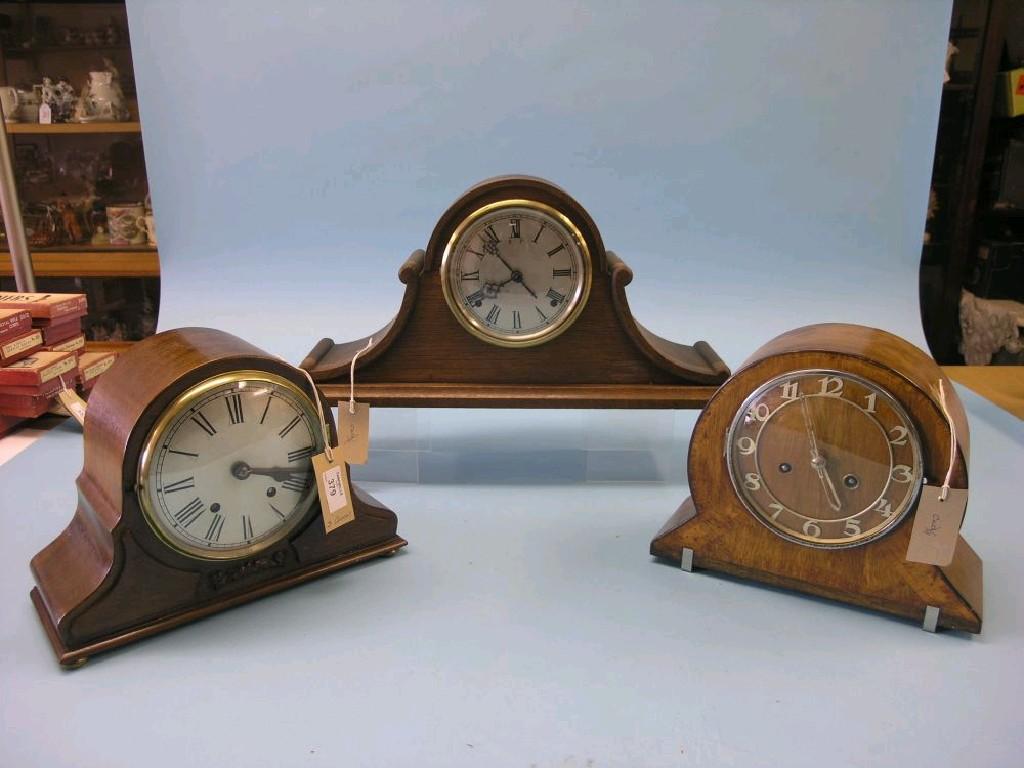 Appraisal: An oak mantel clock domed-shape with C-scrolls in and two