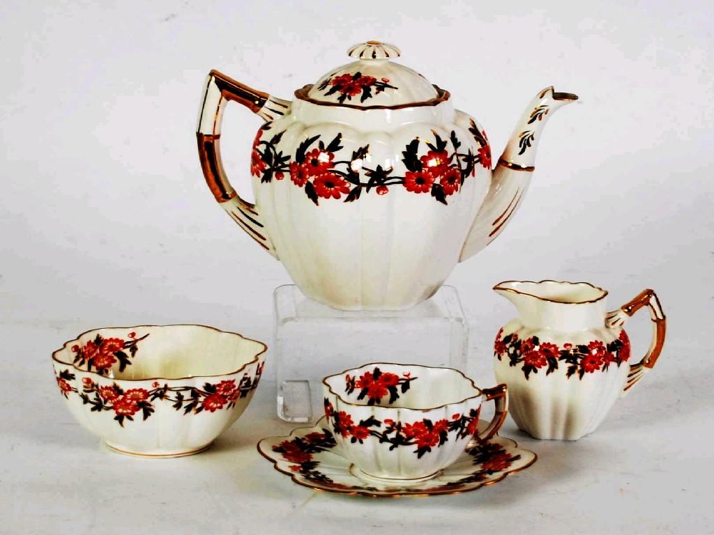 Appraisal: FOURTEEN PIECE VICTORIAN CHINA PART TEASET lobated with red and