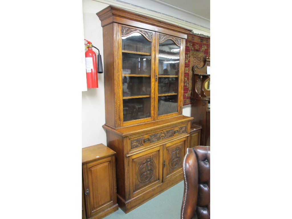 Appraisal: Victorian oak glazed bookcase on cupboard base