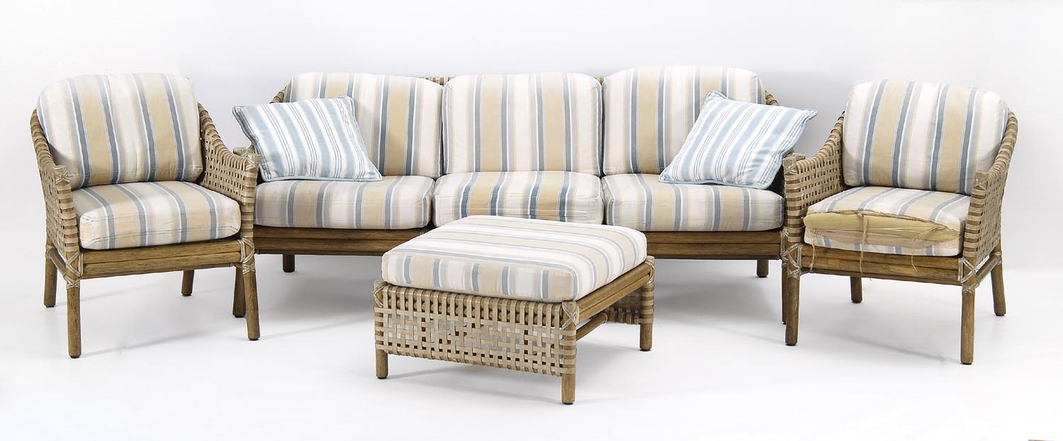 Appraisal: FOUR-PIECE VINTAGE RATTAN SET with leather wrapping Includes a sofa