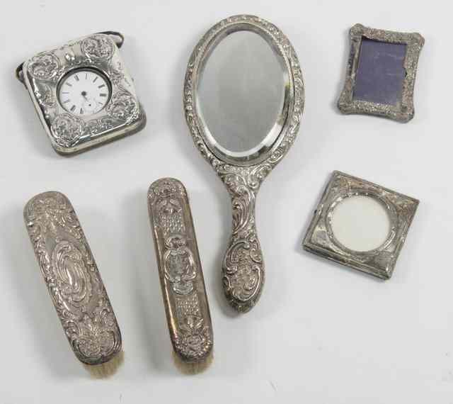 Appraisal: A silver watch case Birmingham embossed cherubs to the corners