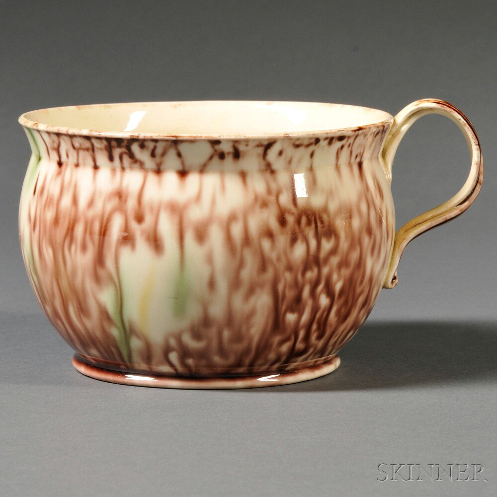 Appraisal: Staffordshire Cream-colored Earthenware Porridge Cup England c entwined strap handle