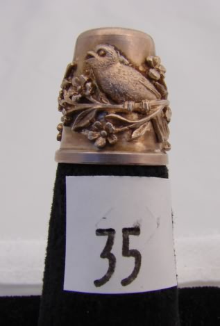 Appraisal: Sterling thimble with bird floral carved design