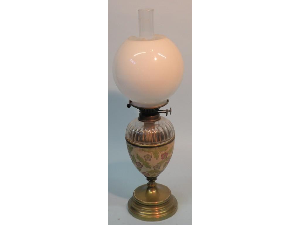 Appraisal: A Victorian pottery glass and brass oil lamp the fittings