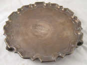 Appraisal: A silver waiter on leaf scroll feet with Chippendale rim