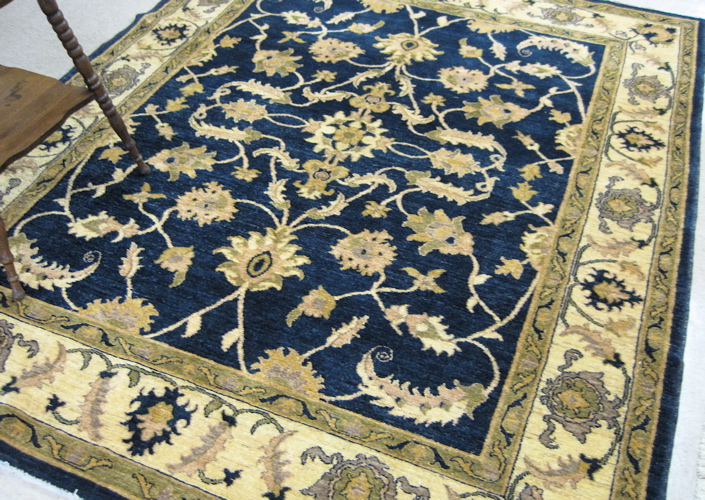 Appraisal: AN AFGHANI PERSIAN CARPET having a floral decorated dark blue