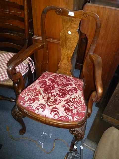 Appraisal: A WALNUT VASE SPLAT BACK OPEN ARMCHAIR standing on shaped