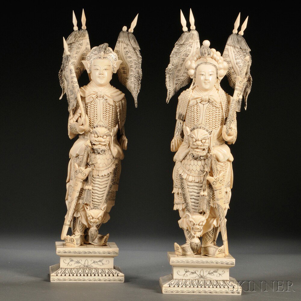 Appraisal: Ivory Carvings of an Armored Couple China standing figures wearing