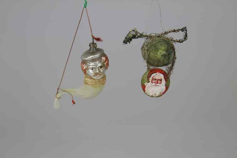 Appraisal: SANTA IN AIRSHIP SAILOR IN PIPE ORNAMENTS Two glass Christmas