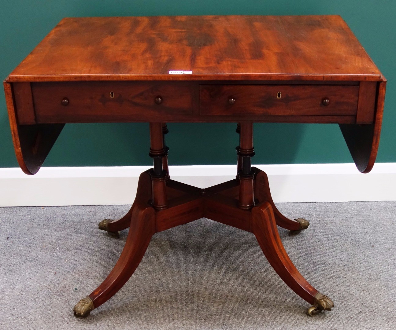 Appraisal: An early th century mahogany sofa table with opposing frieze