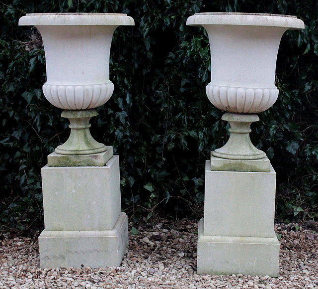 Appraisal: A PAIR OF HADDON STONE URNS of campana form each