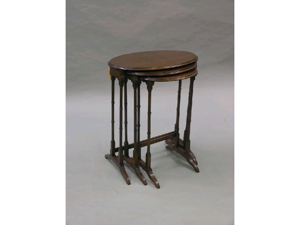 Appraisal: An oval mahogany nest of three tables on slim turned