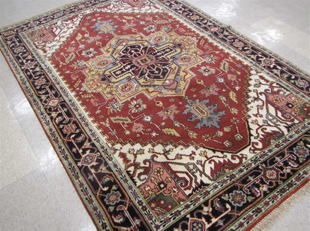 Appraisal: HAND KNOTTED ORIENTAL CARPET Persian Serapi design central geometric medallion