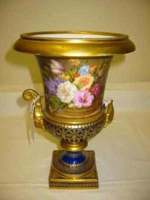 Appraisal: A PORCELAIN URN of campagna form with mask scroll handles