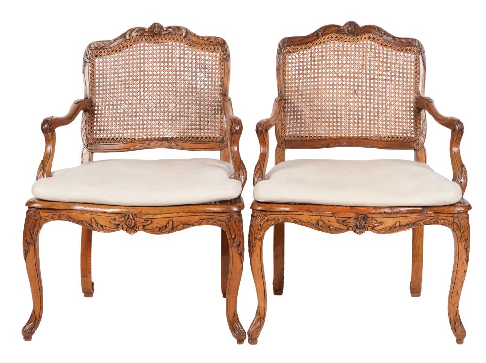 Appraisal: PAIR OF LOUIS XV STYLE CARVED FRUITWOOD FAUTEUILSwith cane back