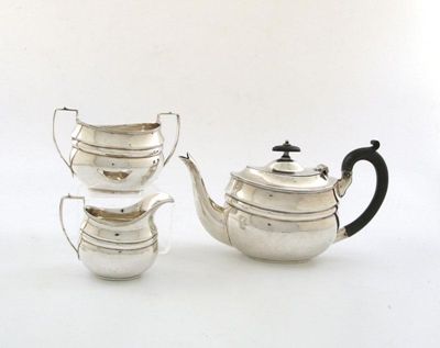 Appraisal: A three-piece silver bachelor's tea set of oval bellied form