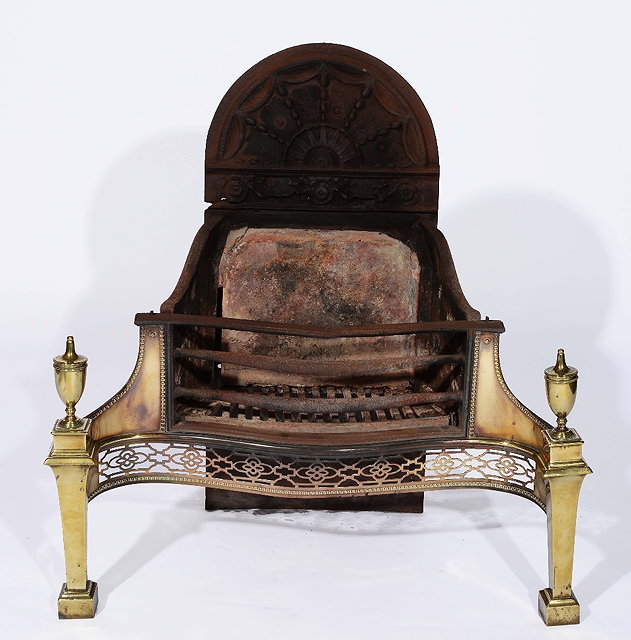 Appraisal: An Adam style cast iron and brass fire grateof serpentine