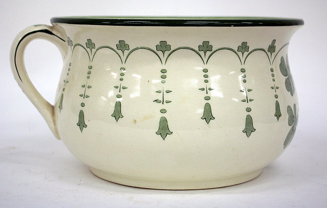 Appraisal: A WHITE GLAZED POTTERY JARDINIERE decorated with ivy together with