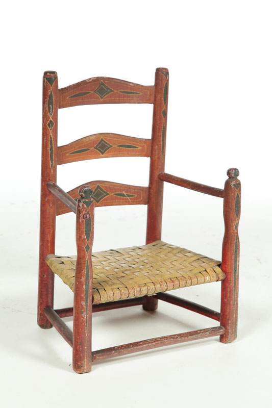 Appraisal: DECORATED CHILD'S ARMCHAIR American th century mixed woods Shaped slats