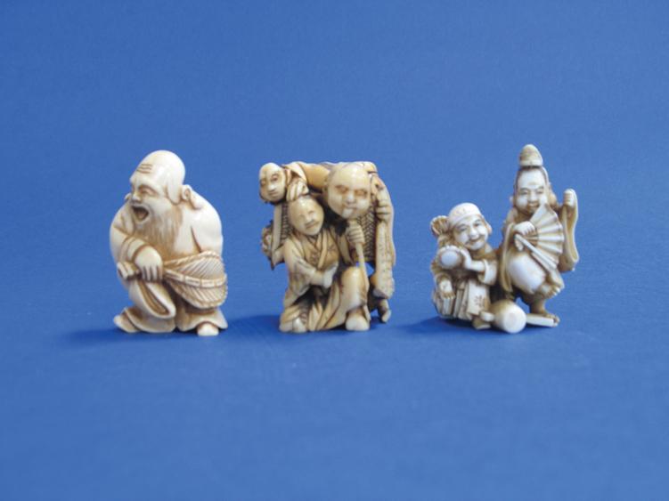 Appraisal: A JAPANESE IVORY OKIMONO of two street players one dancing