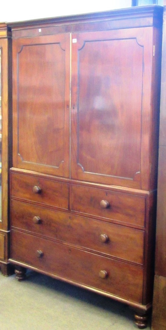 Appraisal: A George III mahogany linen press with two short and