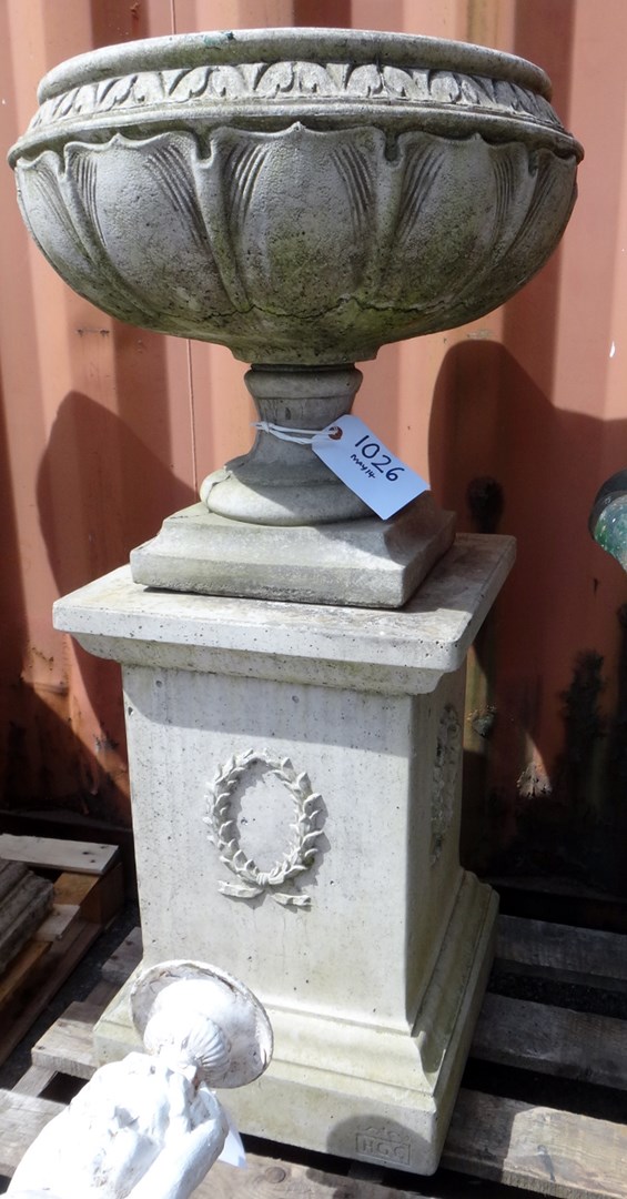 Appraisal: A reconstituted stone urn with swag moulded body on stepped