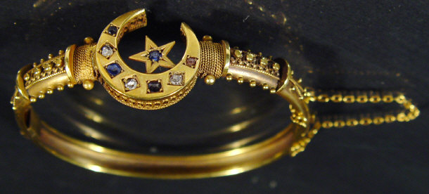 Appraisal: Victorian unmarked gold diamond and sapphire moon shaped bangle