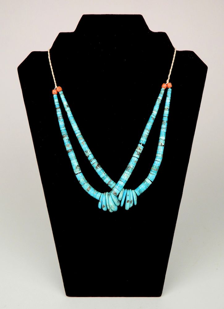 Appraisal: A Turquoise Jackla A Turquoise Jackla with coral ends and