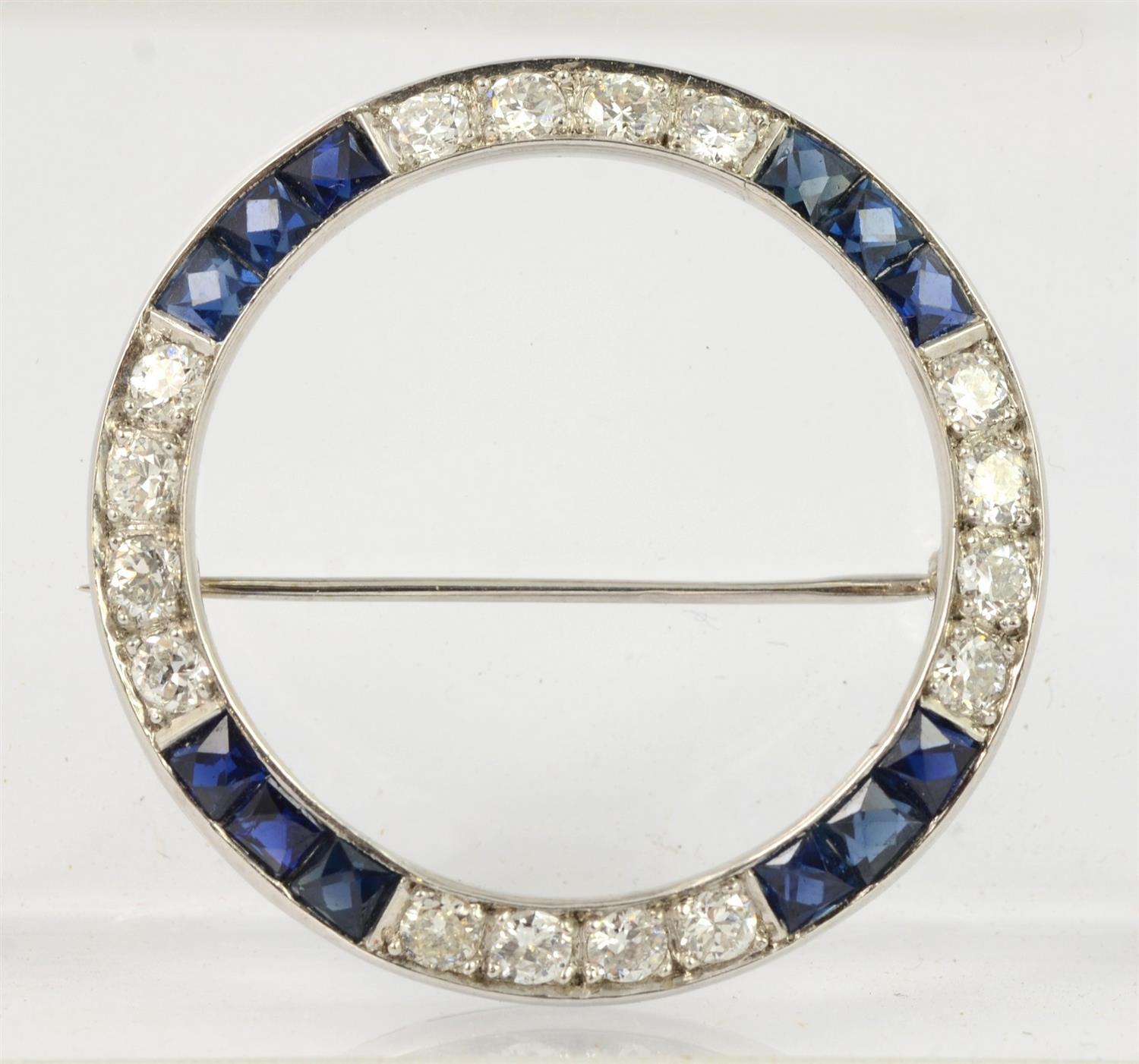 Appraisal: Platinum diamond sapphire circle pin caliber cut sapphires channel set