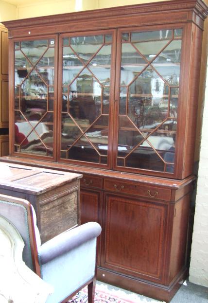 Appraisal: An Edwardian mahogany and satinwood banded library bookcase by Waring