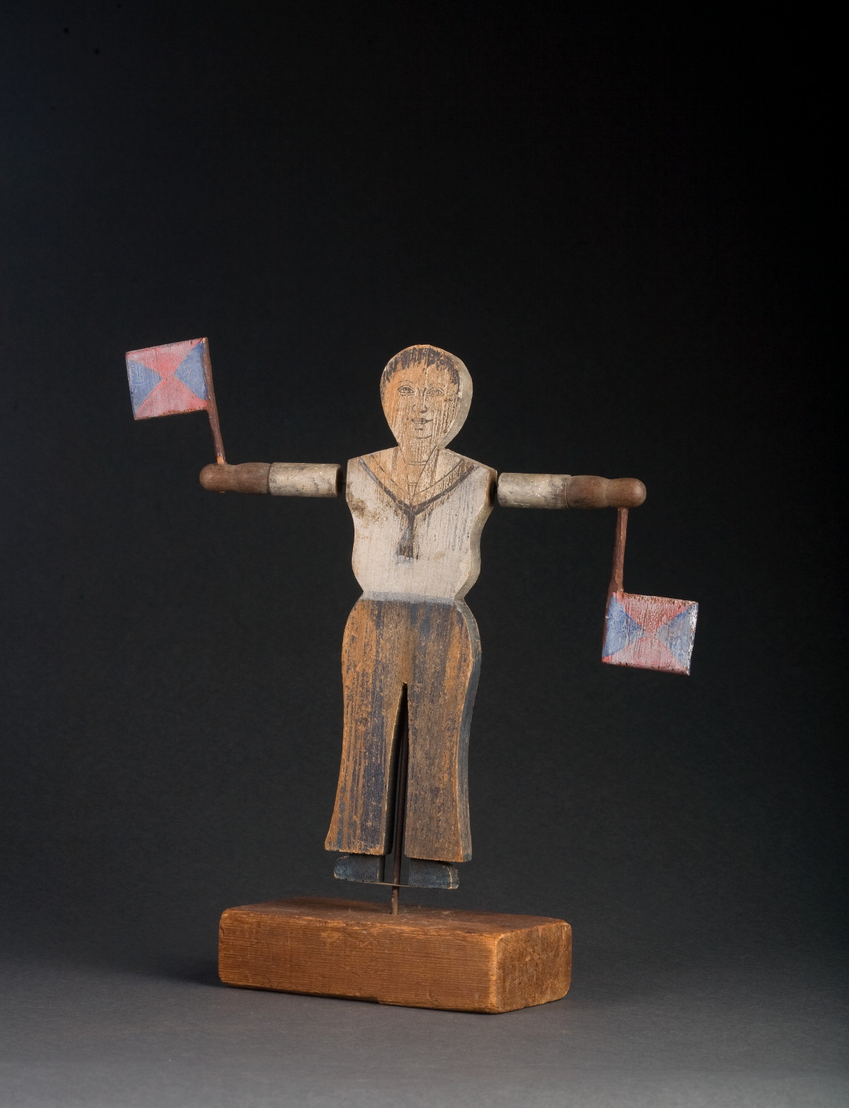 Appraisal: CARVED AND PAINTED WHIRLIGIG OF A SAILOR WITH SIGNAL FLAGS