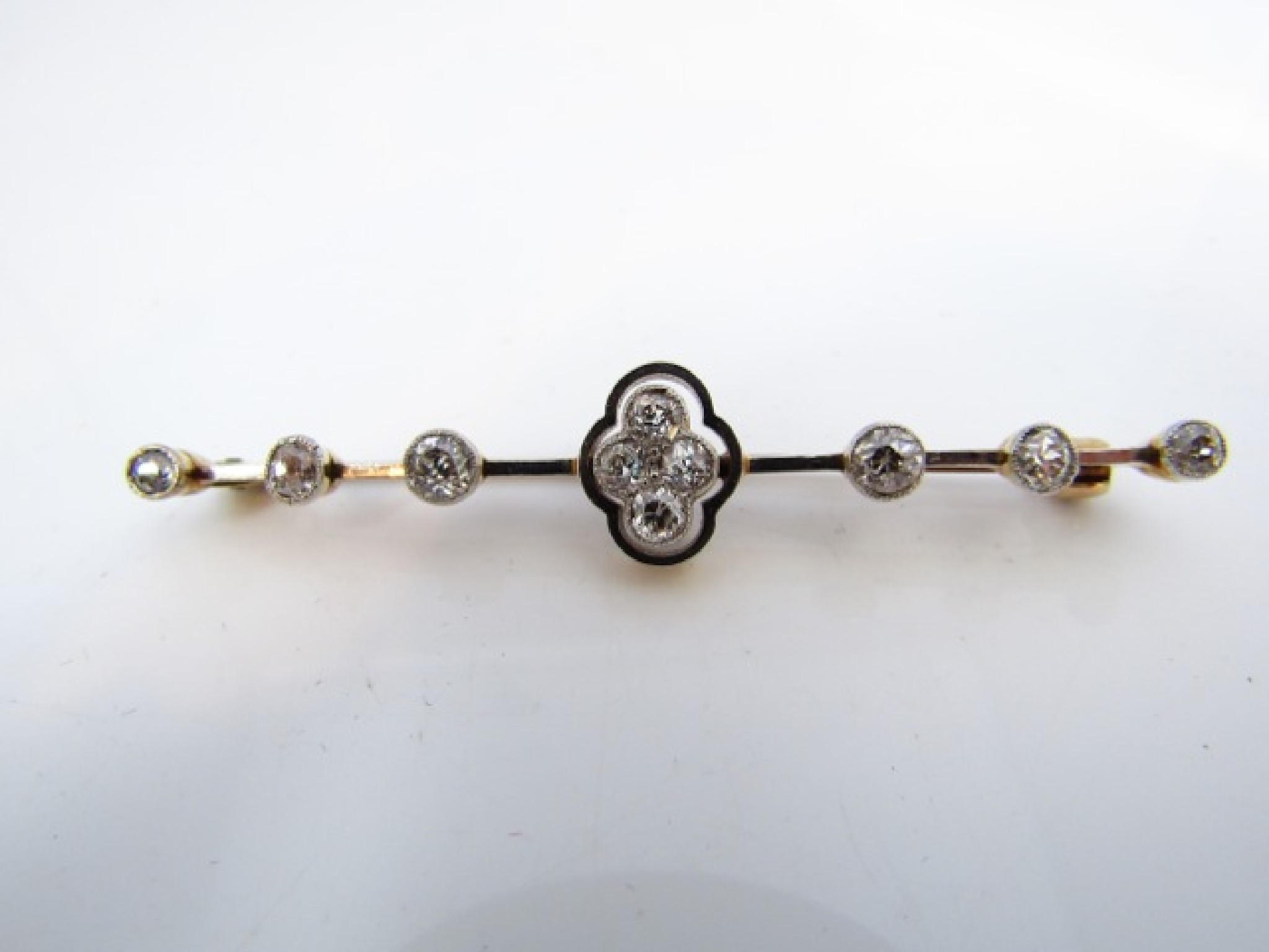 Appraisal: A diamond bar brooch centred with a cluster of four