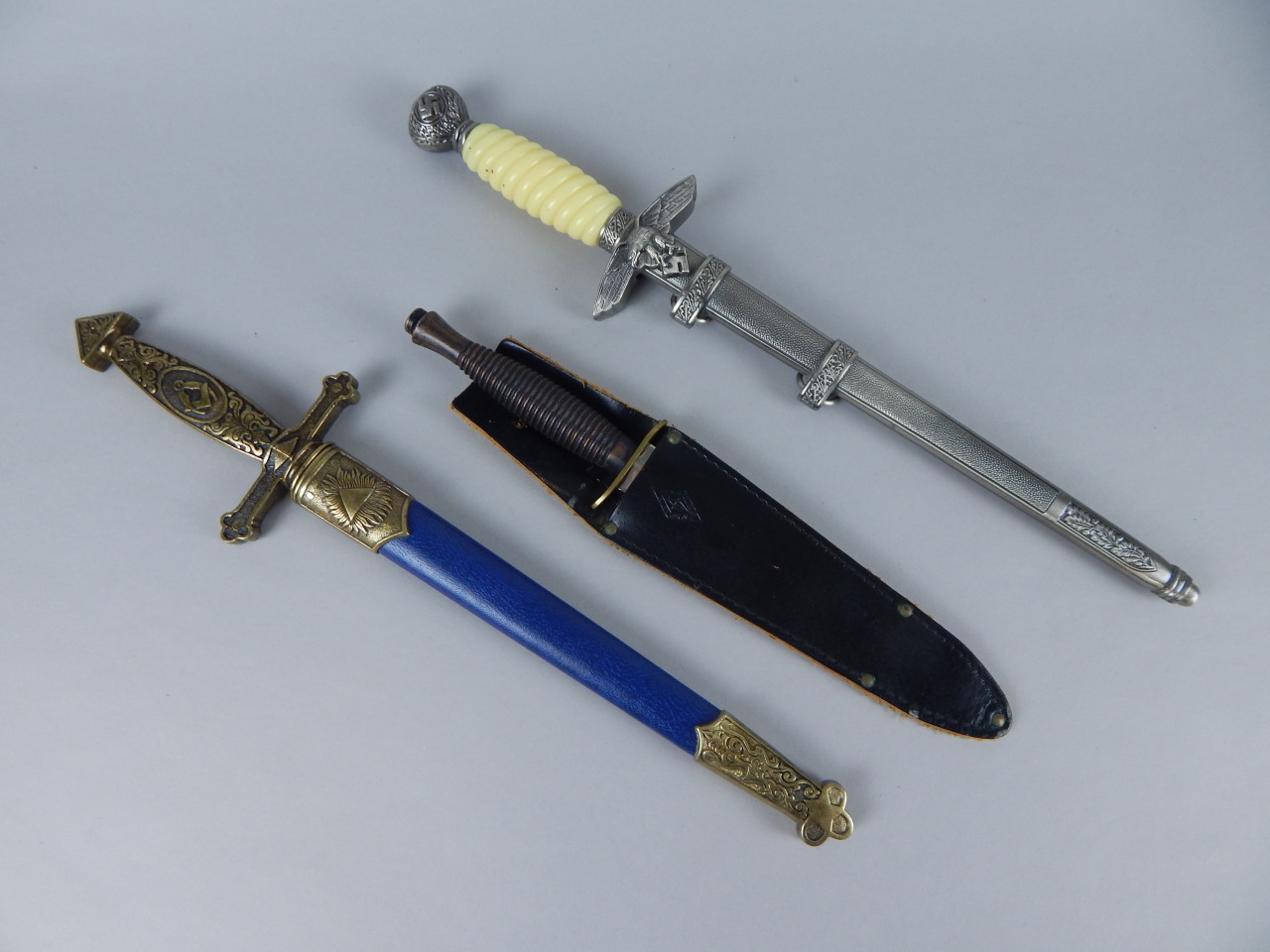 Appraisal: Three reproduction knives a Third Reich dagger a dress dagger