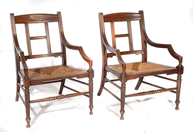 Appraisal: A PAIR OF ARTS AND CRAFTS WALNUT OPEN ARMCHAIRS each