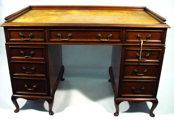 Appraisal: Edwardian walnut twin pedestal desk with tooled leather gallery top