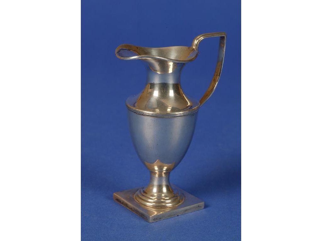 Appraisal: A SILVER CREAM JUG of vase form and a reeded