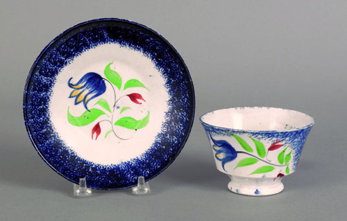 Appraisal: Blue spatter cup and saucer th c with blue tulip