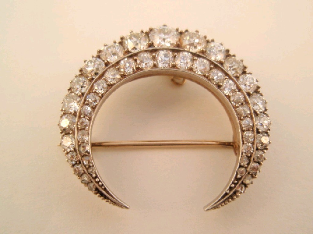 Appraisal: A Victorian double row diamond crescent brooch the largest diamond