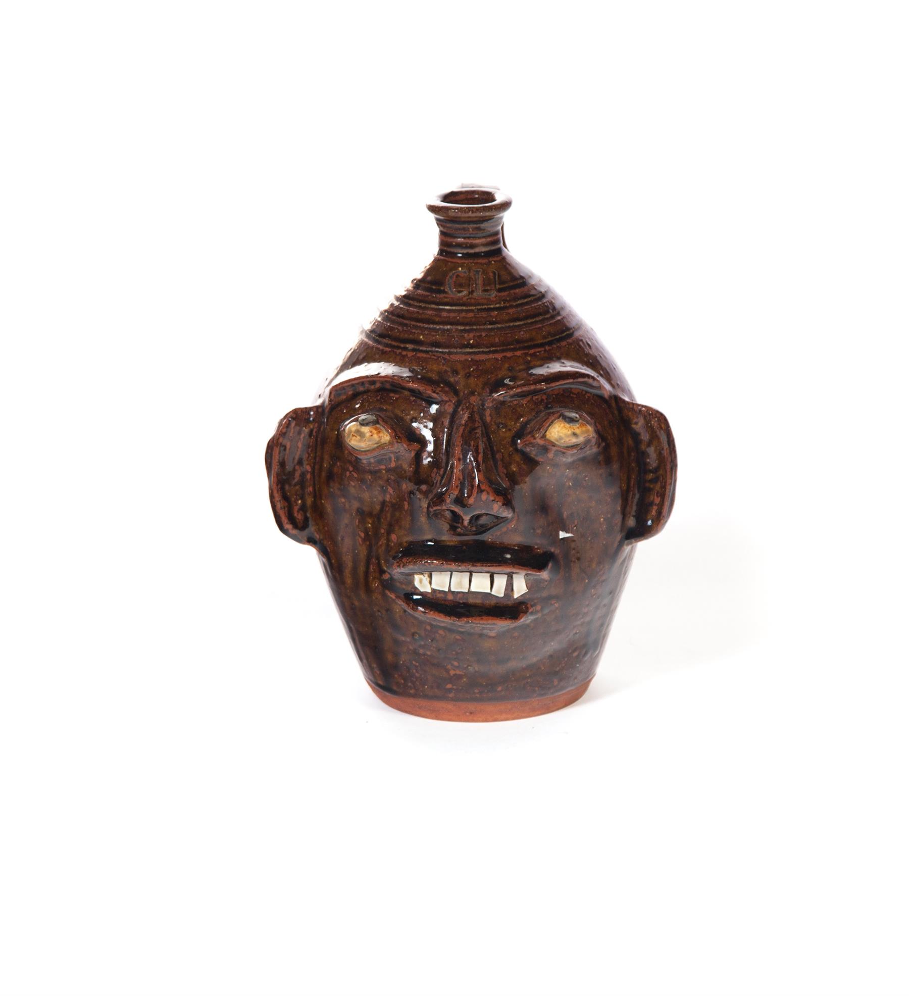 Appraisal: GROTESQUE FACE JUG American late th-early st century Redware with