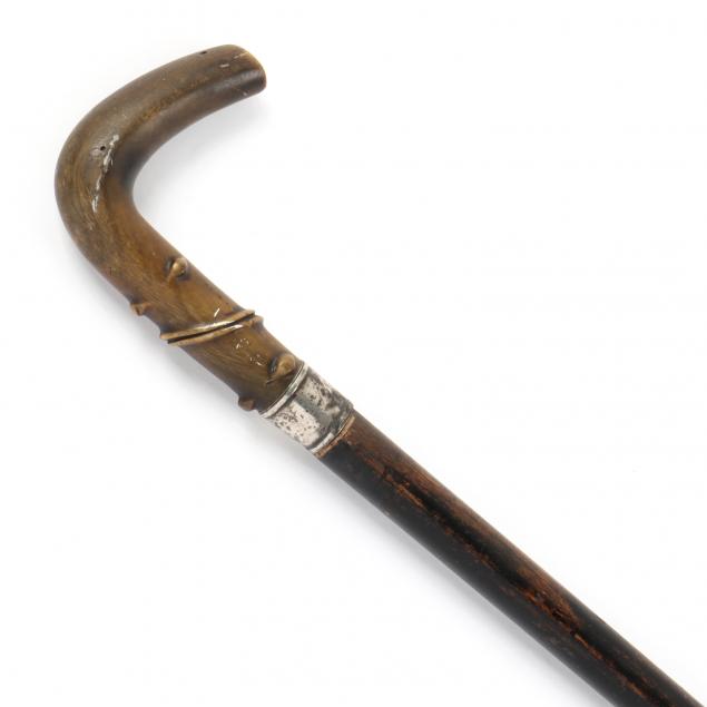 Appraisal: HORN AND STERLING SILVER HANDLED DAGGER CANE Carved horn hook