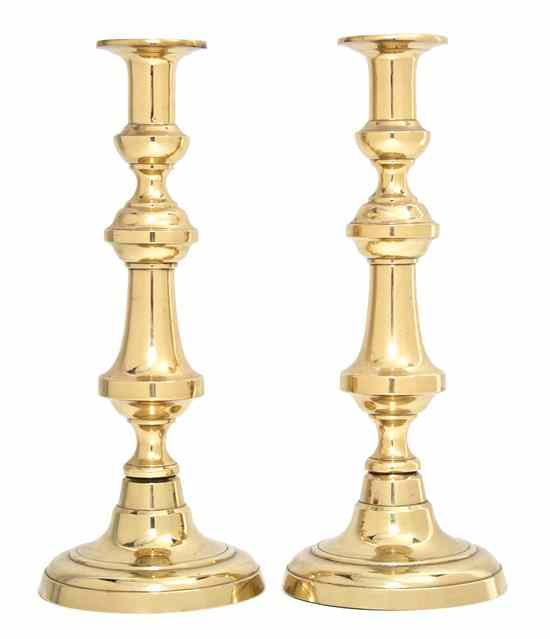 Appraisal: A Pair of Continental Brass Candlesticks having a repeating baluster