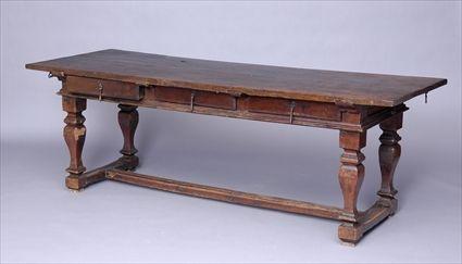 Appraisal: CONTINENTAL BAROQUE WALNUT CENTER TABLE The rectangular overhang top above