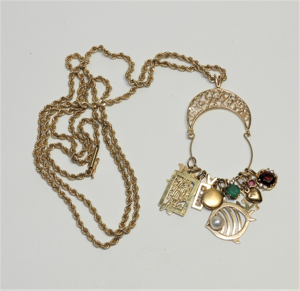 Appraisal: KT GOLD ROPE CHAIN MULTI CHARM NECKLACE C Includes ten