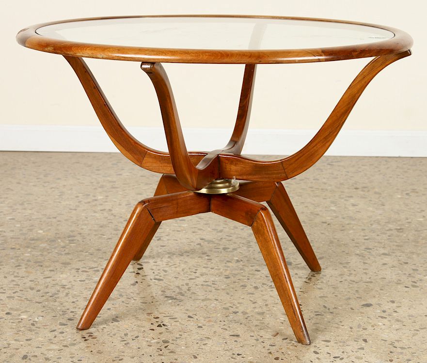 Appraisal: MAHOGANY GLASS COFFEE TABLE SPIDER FORM LEGS A mid century