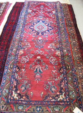 Appraisal: TWO PERSIAN RED FIELD HAMADAN AREA RUGS both floral design